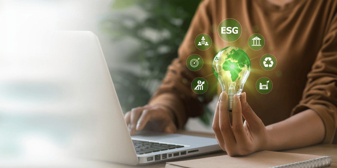 Man workng on laptop with light bulb